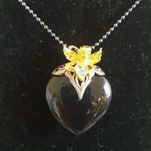 Black Stone Heart set with a gold tone Cherub